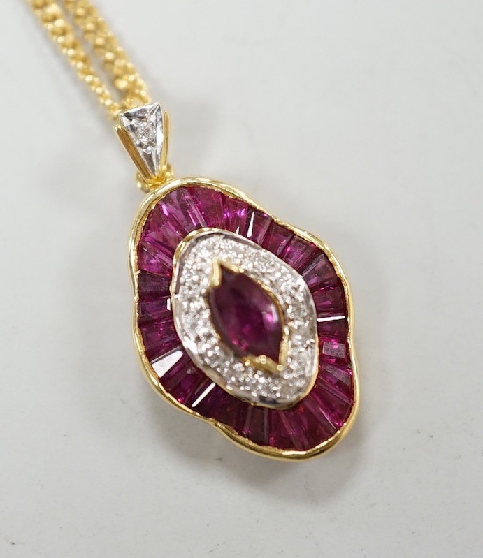 A modern 18k yellow metal, ruby and diamond cluster set quatrefoil shaped pendant, overall 25mm, on an 18ct gold fine link chain, 44cm, gross weight 8.1 grams.